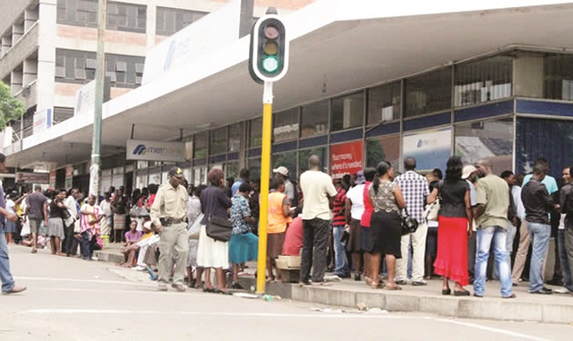 Clients stand outside a Bulawayo bank for their chance to do transactions in this file picture. Zimbabwe is facing severe cash shortages that have resulted in long queues at banking halls, and this has negatively affected both the formal and informal sectors
