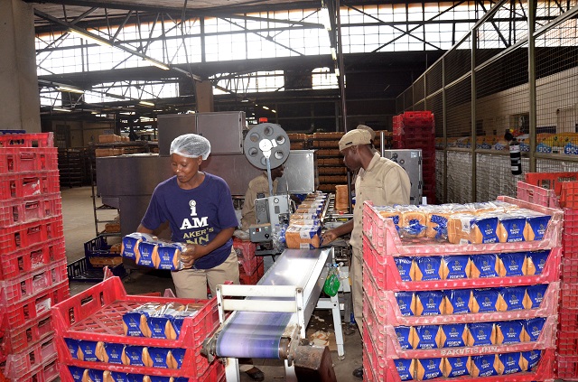 Baker's Inn workers package bread at their Bulawayo plant in Belmont.