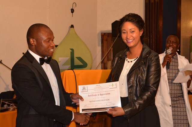 ZBCA Midlands region president Mr Tinashe Manzungu hands over a certificate of appreciation to an Alpha construction representative