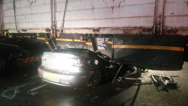 The wreckage of the Mazda 3 in which they were travelling