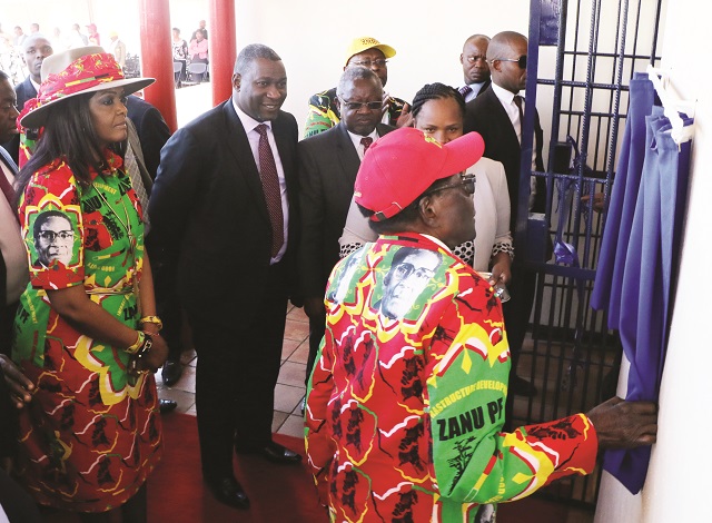 President Mugabe unveils a plaque as he officially opens the Lupane Post Office and ICT community centre yesterday. Looking on (from left) are the First Lady Amai Grace Mugabe and Information Communication Technology, Postal and Courier Services Minister Supa Mandiwanzira and other dignitaries