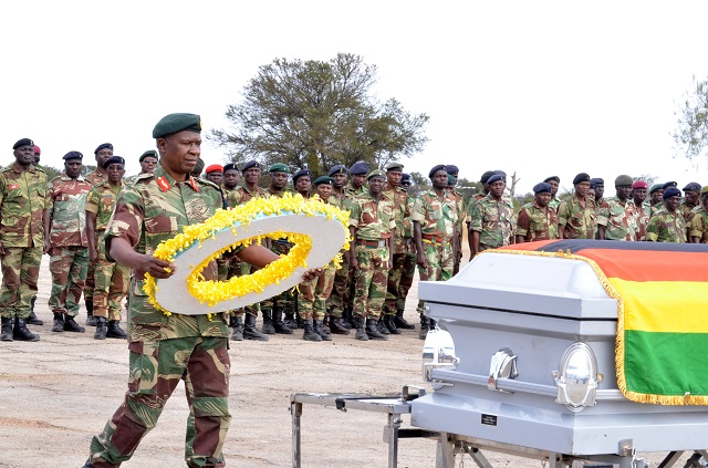Zimbabwe National Army (ZNA) Commander Lieutenant-General Philip Valerio Sibanda lays a wreath on the coffin of the late Lt-Colonel Eddie Sigoge Mlotshwa at Imbizo Barracks yesterday