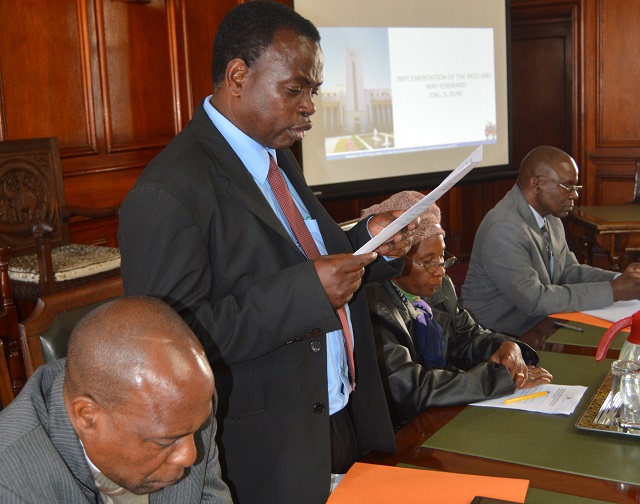 The Bulawayo City Town Clerk Mr Christopher Dube (second from left) presents the Policy Direction during the Bulawayo City Council and the Umguza Rural District Council memorandum of understanding (MoU) on the development of housing stands at Rangemore plots at the Council Chambers yesterday. Listening (from left) is the Umguza RDC CEO Mr Collen Moyo and next to Town Clerk on the right is Umguza Councillor Priscilla Sithole for Ward 16 and Bulawayo Mayor Clr Martin Moyo. — Picture by Dennis Mudzamiri