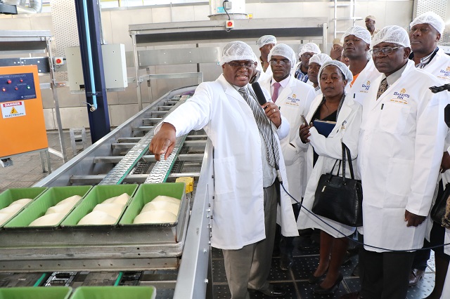 Baker's Inn chief executive officer Mr Ngoni Mazango (left) leads a tour of Leonard Plant 3 after its official opening in Bulawayo last Friday