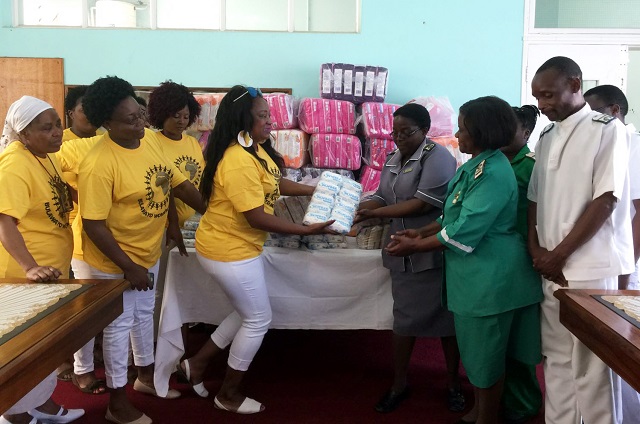 Bulawayo Women of Courage presented sanitary pads and soap worth more than $400 to Ingutsheni Central Hospital in Bulawayo. In this picture Mrs Sinikiwe Dube Mutsure hands over the donation to Matron Sithabisiwe Nhlabano-Ndlovu while other members of staff look on.— (Picture by Nyaradzo Bakari)