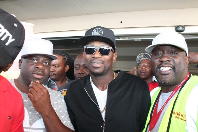 Busy Signal (centre) surrounded by bouncers