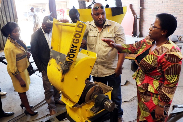 Deputy Minister of Industry and Commerce Chiratidzo Mabuwa stresses a point to Ivory Gold Company operations director Mr Tyron Frank during the company tour in Belmont, Bulawayo, yesterday