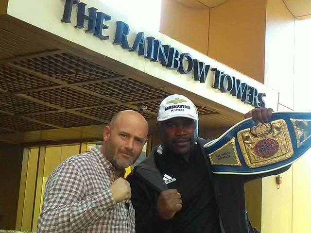Elvis Moyo poses for a picture with one of the officials from the promoters company in Harare yesterday