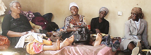 Mourners at the Emganwini suburb house where 4 children and their mother were poisoned