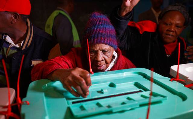 Lydia Gathoni Kiingati, 102, casts her vote just after dawn at a polling station