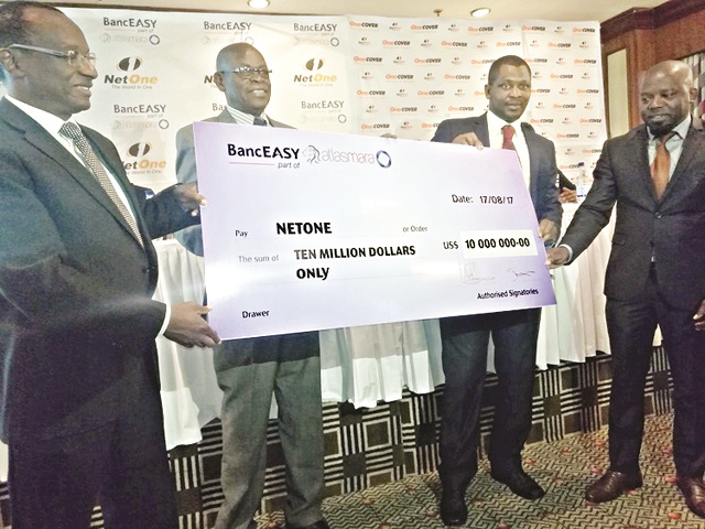 NetOne acting chief executive Mr Brian Mutandiro (left), acting chairman Peter Chingoka (second from left) and acting chief operations officer Clever Isaya (extreme right) receive the symbolic cheque for OneTech from BancABC official James Wade