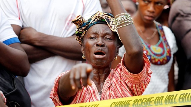 A woman weeps after learning she had lost her son in Freetown on Wednesday. —Reuters