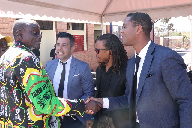 Dutch football legend Patrick Kluivert (right) greets the Minister of State Security Kembo Mohadi upon his arrival at Jahunda Community Information Centre in Gwanda on Saturday. On Kluivert's right is another legend Edgar Davids as well as Spanish legend Rayco Garcia
