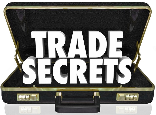 The words Trade Secrets in an opening black leather briefcase to