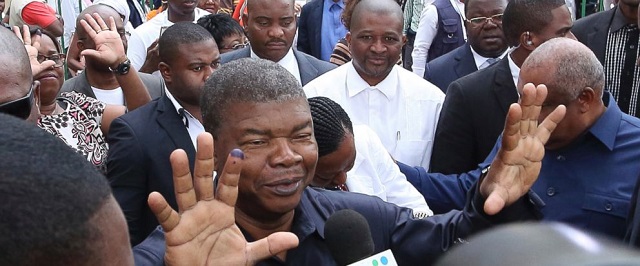Defence minister Joao Lourenco, shows his ink-stained finger as he faces the media after casting his vote in elections in Luanda, Angola. — AP