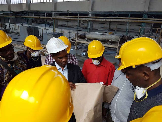 Kadoma Paper Mills general manager Mr Mackson Maturura (white helmet, centre) shows business journalists from different media houses some of the milling operations during a tour of the company yesterday. — Picture by Tinashe Makichi