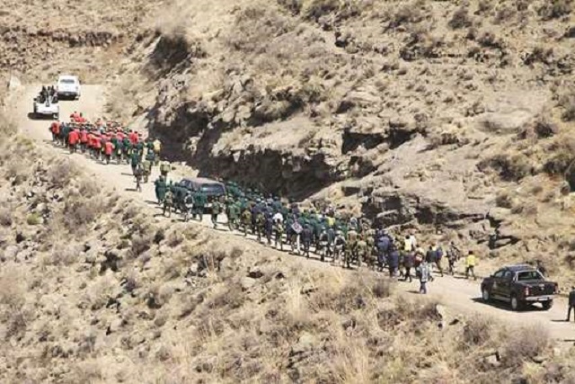 The coffin of Army Lieutenant-General Khoantle Motsomotso is carried in procession at his funeral in Malibamatso. King Letsie III said that the killing of the country's army commander last week had caused 'embarrassment' and 'scared' the small mountain kingdom.