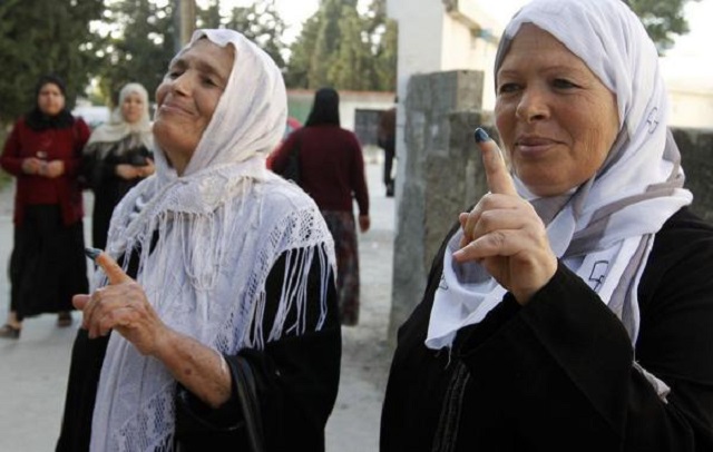 Tunisian women show their inked fingers after voting on October 23, 2011, at Tunisia in a polling station. On Thursday, the Tunisian government lifted a ban that prohibited Muslim women from marrying non-Muslims. Photo by Hichem Borni/UPI