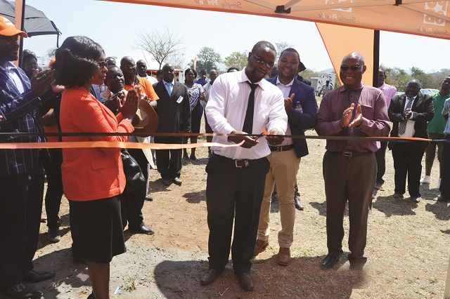 Masvingo provincial epidemiology and diseases control officer Dr Tapera Saravoye cuts the ribbon to mark the commissioning of a borehole at Neshuro District Hospital in Mwenezi last Friday. Looking on (from left) is POSB general manager operations Ms Hope Marere, Neshuro District Hospital medical director Dr Itai Matibiri and POSB Public Relations Manager Mr Simukayi Mutamangira