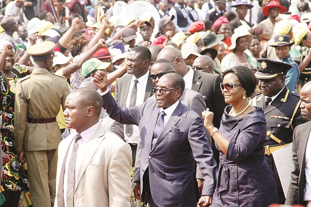 President Mugabe and First Lady Dr Grace Mugabe greet supporters at the burial of Gogo Maria Msika at the National Heroes' Acre in Harare yesterday —Picture by John Manzongo