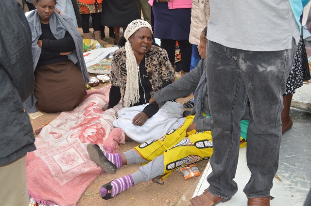 Mrs Abigail Siziba, the late Menzele's mother, next to her son's body yesterday