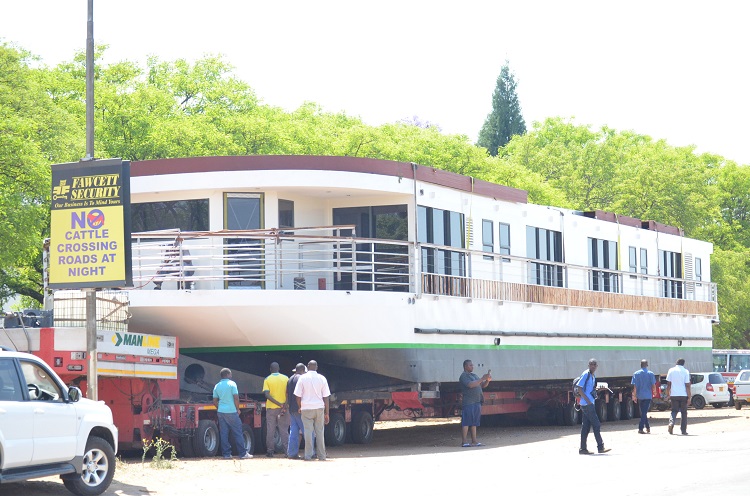 The African Dream as it passes through Bulawayo with residents taking "selfies" while posing next to the houseboat
