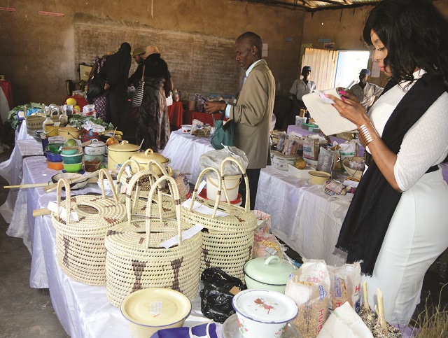 One of the officials, Mrs Lerato Sibanda, (right) judges women's craft work during the Gwelutshena Women's Fair at Gwelutshena business centre in Nkayi district yesterday