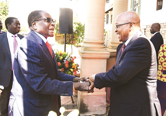 President Mugabe is welcomed by his South African counterpart President Jacob Zuma at the second session of the Zimbabawe-South Africa Bi National Commission in Pretoria yesterday. — (Picture by Presidential Photographer Joseph Nyadzayo)