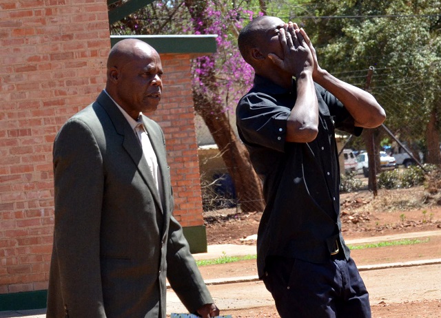 An unidentified man (left) accompanies Shadreck Matsose who caused chaos at his grandfather's funeral in Bulawayo on Monday