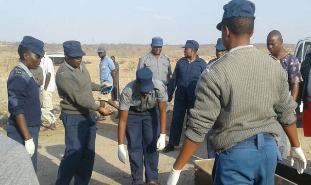 Police collect the body of Mr Cliff Chioza, the taxi driver who was killed