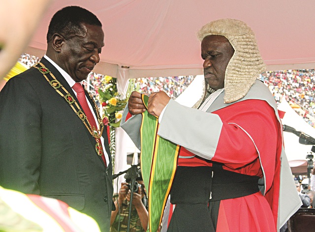 President Emmerson Mnangagwa is sworn in by Chief Justice Luke Malaba during his inauguration at the National Sports Stadium in Harare yesterday.