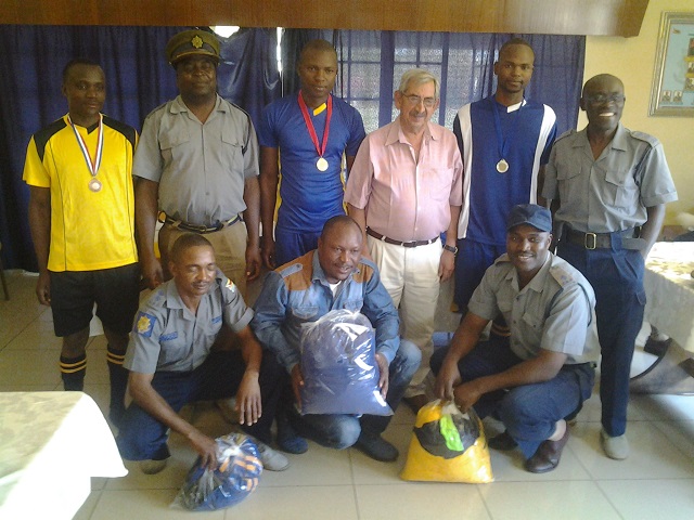 Townshend and Butcher's Peter Leodios (centre) poses with police representatives after handing over the sponsorship package at Ross Camp in Bulawayo yesterday