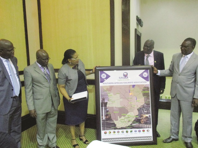 Ex-Minister of Transport, Dr Joram Gumbo (far right) receives a map showing railways network system from Southern African Railways' Association (Sara) board members during a conference in Victoria Falls yesterday
