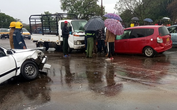 The accident scene in which a Honda Fit (red car) driver lost control and rammed into two cars at the robot-controlled intersection of Nketa Drive and Khami Road in Mpopoma suburb, Bulawayo, yesterday morning. — (Pictures by Prince Sunduzani)