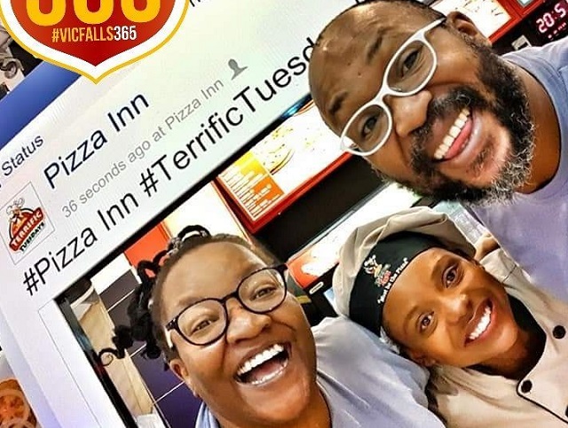 Carl Joshua Ncube and wife Nelsy (left) and a Pizza Inn staffer