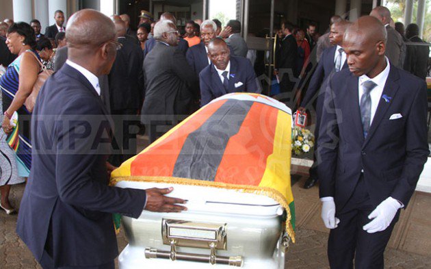 Pall-bearers carry a casket bearing the body of national hero Dr Timothy Stamps during a memorial service in Harare yesterday. — Picture by Justin Mutenda