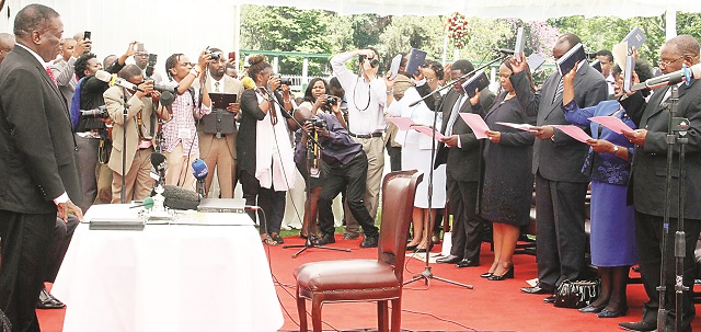 President Emmerson Mnangagwa swears in cabinet ministers at State House in Harare yesterday. — (Picture by Tawanda Mudimu)